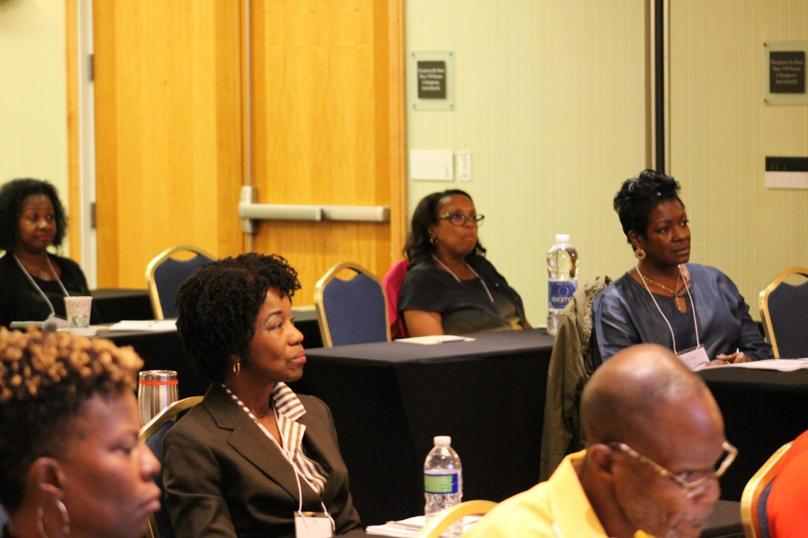 A group of people sitting in front of a room.